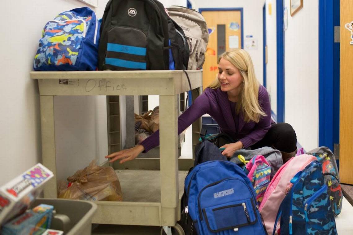 Melissa Plum, a social worker at Lynn Road Elementary School in Raleigh, packs book bags with food in this 2015 file photo. Plum delivered the bags to students who are part of the Backpack Buddies program.