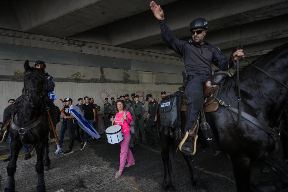 Israeli police use horses to disperse Israelis protesting against plans by Prime Minister Benjamin Netanyahu's government to overhaul the judicial system in Tel Aviv, Israel, Thursday, March 23, 2023to . (AP Photo/Ohad Zwigenberg)