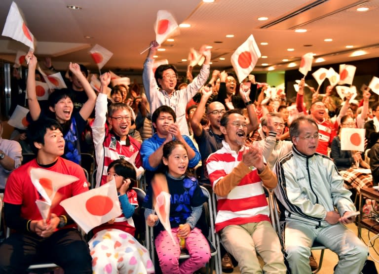 Japanese rugby fans celebrate their team's try during a public broadcast of the 2015 Rugby World Cup match Japan vs USA, in Kumagaya north of Tokyo