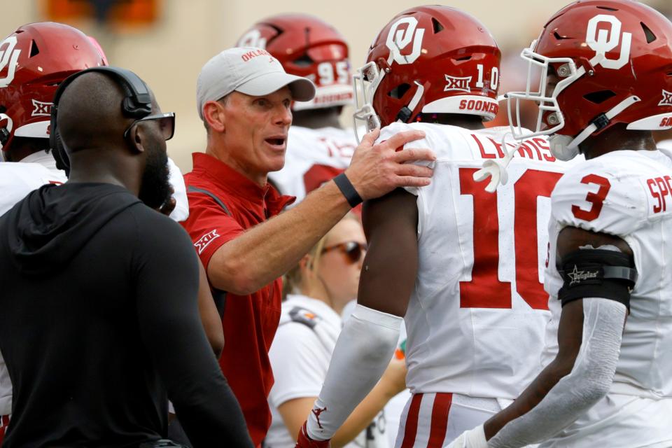 Oklahoma coach Brent Venables talks with Oklahoma Sooners linebacker Kip Lewis (10) during a Bedlam college football game between the Oklahoma State University Cowboys (OSU) and the University of Oklahoma Sooners (OU) at Boone Pickens Stadium in Stillwater, Okla., Saturday, Nov. 4, 2023. Oklahoma State won 27-24.