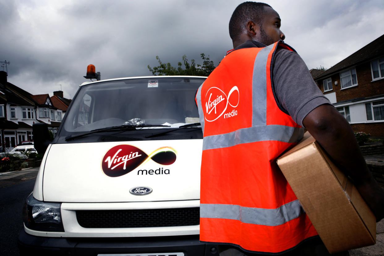 A Virgin Media employee delivering a digital tv reciever. (Photo by: Newscast/Universal Images Group via Getty Images)