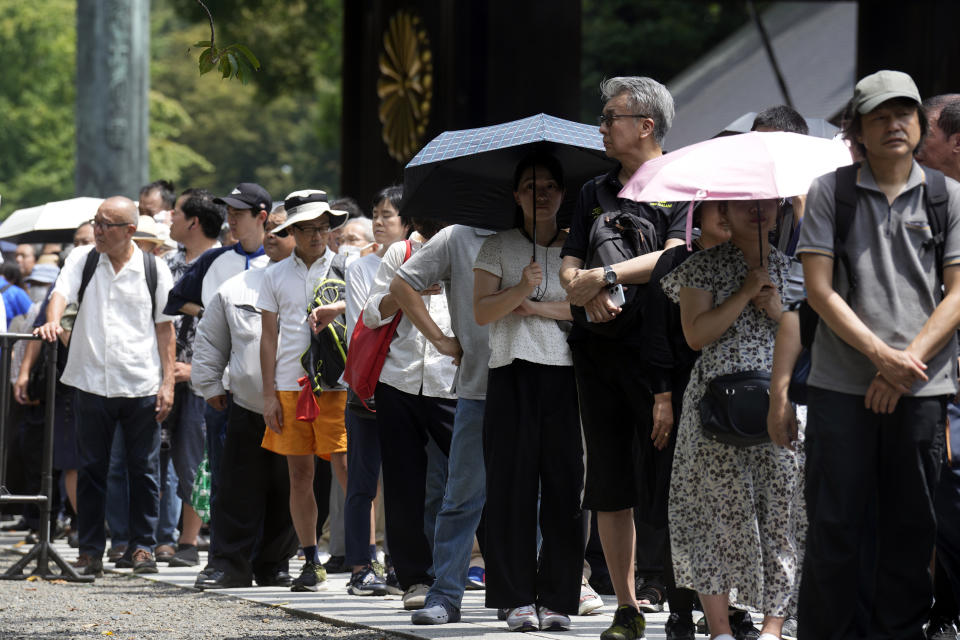 Visitors wait in queue to offer prayers at the Yasukuni Shrine, which honors Japan's war dead, Tuesday, Aug. 15, 2023, in Tokyo. Japan holds annual memorial service for the war dead as the country marks the 78th anniversary of its defeat in the World War II. (AP Photo/Eugene Hoshiko)
