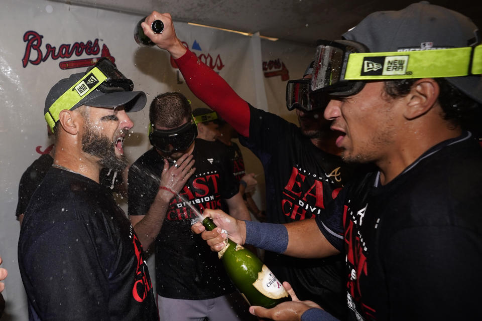 Atlanta Braves' Kevin Pillar celebrates with teammates after the Braves clinched their sixth consecutive NL East title by defeating the Philadelphia Phillies in a baseball game, Wednesday, Sept. 13, 2023, in Philadelphia. (AP Photo/Matt Slocum)