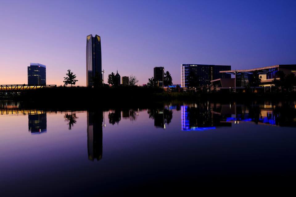 The Oklahoma City downtown skyline is reflected in Scissortail Lake in 2021.