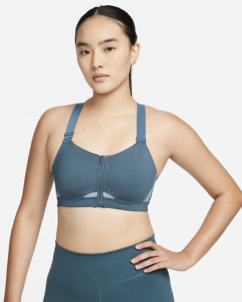 A photo of a model in Nike Alpha Women's High-Support Padded Zip-Front Sports Bra.