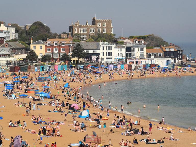 High summer temperatures will finally hit the UK next week when it will be hotter than Barcelona, forecasters have said. But this weekend flood warnings, persistent rain and thundery spells are continuing to plague parts of the country.“Conditions, overall, remain fairly changeable,” said Simon Partridge, a meteorologist at the Met Office. “Saturday’s outbreaks of rain will clear up by nightfall, though we are expecting some rain to continue in northeast England and Scotland.”Overnight temperatures on Saturday will be in the mid to high single figures, he added, sinking to 1C in northern regions.Sunny spells and rain will mingle, with heavy showers on Sunday, when thicker cloud is forecast across northern Scotland.Prolonged rainfall is also expected across the southwest and Wales.“Wales will start dry on Sunday, with the rain getting heavier as the day goes on,” Mr Partridge said. “The main thing, across the UK, is that Sunday will be a lot windier. Very breezy.”Temperatures will improve slightly, rising to 21C in the southeast and 17C across the rest of the UK.Mr Partridge said the conditions were slightly below usual summer temperatures.“We’re a few degrees below where we should be,” he said. “It should be around 22C in the southeast and 19C or 20C elsewhere.”Monday is expected to be mostly dry, though persistent rain will continue in the southwest.But temperatures are set to surge later in the week as an area of low pressure moves into the UK, with parts of the country set to be as warm as Barcelona and Rio de Janeiro.“Tuesday and Wednesday will bring a bit of a change,” Mr Partridge said. “It could get very warm – we could see 26C in the south.”The low pressure system will spread to northern regions, with temperatures in Northern Ireland and Scotland expected to hit 18C.But forecasters also expect the system to bring heavy rain and thundery showers, which will move from the south of the UK to other regions. “It is uncertain at the moment but we are keeping an eye on Lincolnshire where a river has burst its banks,” Mr Partridge said. “We may issue some rainfall warnings at some point next week – that’s the main thing for the public to keep an eye out for.”The Environment Agency (EA) has issued 16 flood warnings and 37 flood alerts, mainly in the midlands and northeastern regions.The Royal Air Force dropped 270 bags of material to fill a breach in the River Steeping in Wainfleet on Friday, after the Lincolnshire town received more than two months’ of rain in just two days.An EA spokesperson said it was working with emergency services in the area over the weekend on measures to tackle the flooding.Additional reporting by agencies