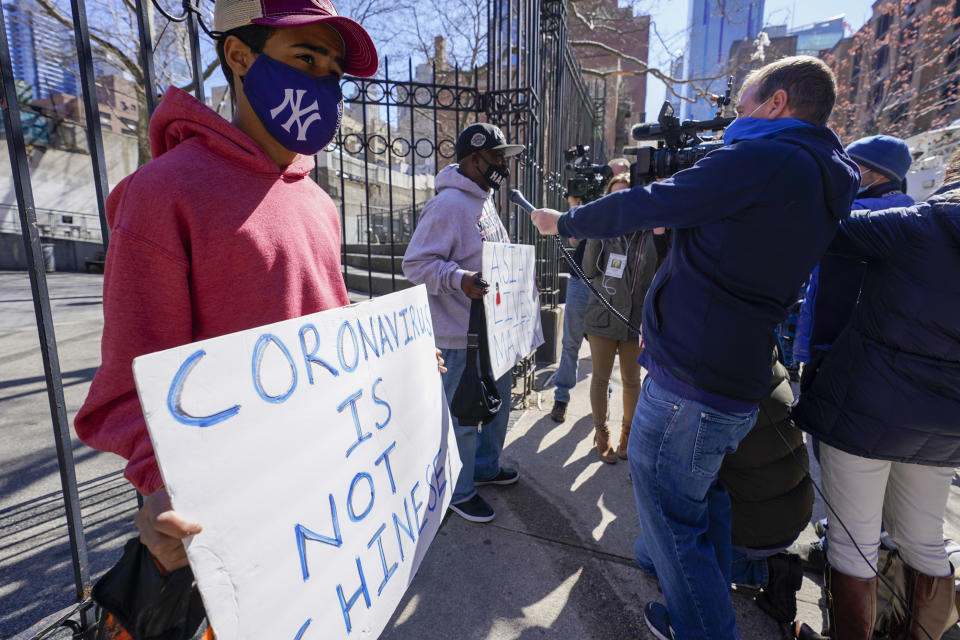 Community activists Calvin, right, and Cameron Hunt speak to reporters outside the building where an Asian American woman was assaulted, Tuesday, March 30, 2021, in New York. The New York City Police Department says an Asian American woman was attacked by a man Monday afternoon who repeatedly kicked her in front of witnesses who seemingly stood by. (AP Photo/Mary Altaffer)