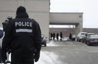 Police watch as people come and go for the visitation of Vito Rizzuto, head of the infamous Rizzuto crime family, in Montreal December 29, 2013. Rizzuto died of natural causes in a hospital on December 23, 2013. REUTERS/Christinne Muschi (CANADA - Tags: CRIME LAW OBITUARY SOCIETY)