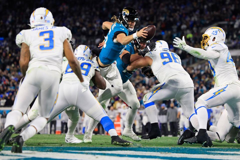 Jaguars' quarterback Trevor Lawrence, seen here reaching the ball over the goal line for a two-point conversion against the Los Angeles Chargers in an AFC wild-card victory, has a chance to do what Joe Burrow did for the Cincinnati Bengals in ascending his franchise to postseason success.