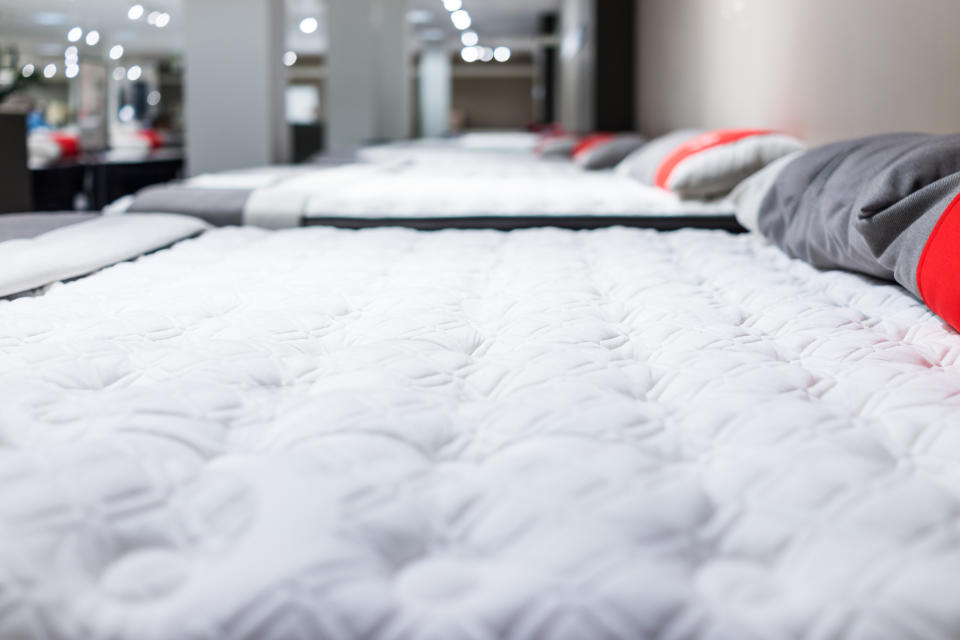 Closeup of many mattresses on display in store