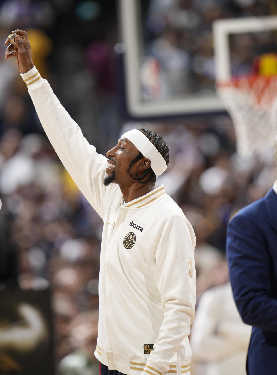 Denver Nuggets guard Kentavious Caldwell-Pope holds up his NBA championship ring before the team's NBA basketball game against the Los Angeles Lakers on Tuesday, Oct. 24, 2023, in Denver. (AP Photo/David Zalubowski)