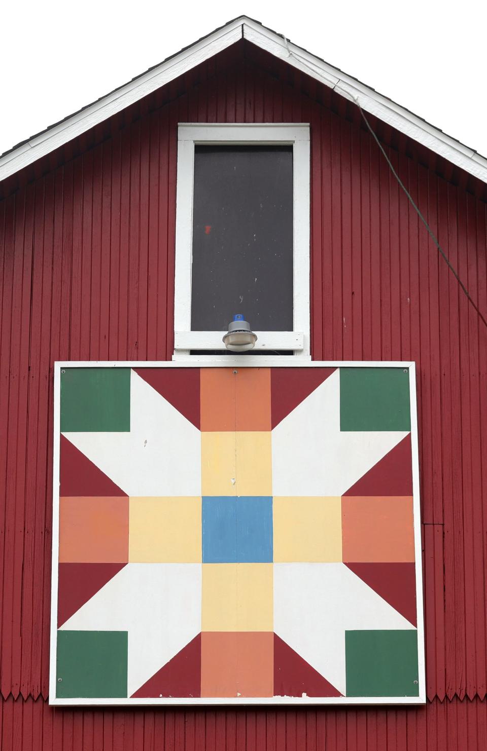 A barn at the Crown Point Ecology Center in Bath has a colorful quilt design.