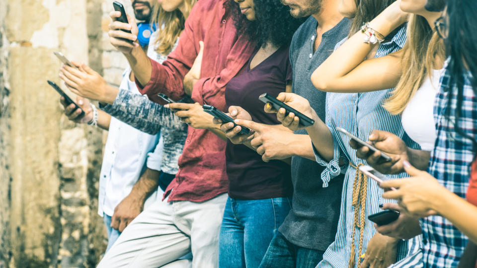 A group of people looking at their smartphones