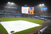A tarp covers the infield after a scheduled baseball game between the Detroit Tigers and the New York Mets was postponed for inclement weather, Tuesday, April 2, 2024, in New York. (AP Photo/Frank Franklin II)
