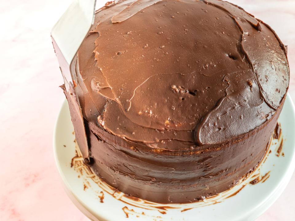 a layer cake covered in chocolate frosting