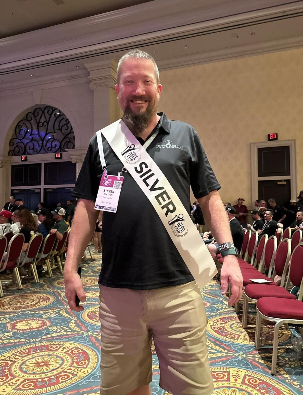 Steve Clayton, owner of Three Leg Run Brewery-Winery-Meadery, strikes a pose after his English Ale 'Working An Angle' places silver at the World Beer Cup competition in Las Vegas on April 24, 2024.