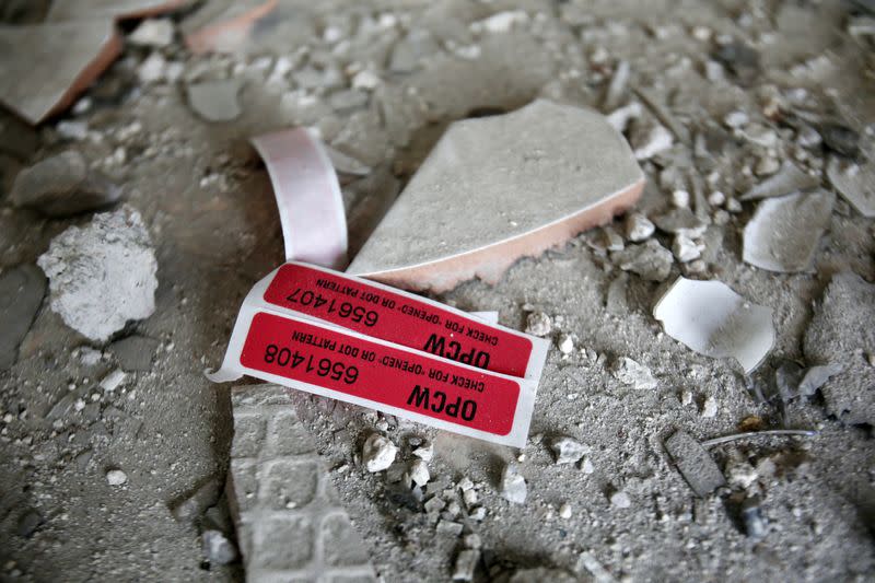 Labels of the Organisation for the Prohibition of Chemical Weapons (OPCW) are seen iside a damaged house in Douma in Damascus