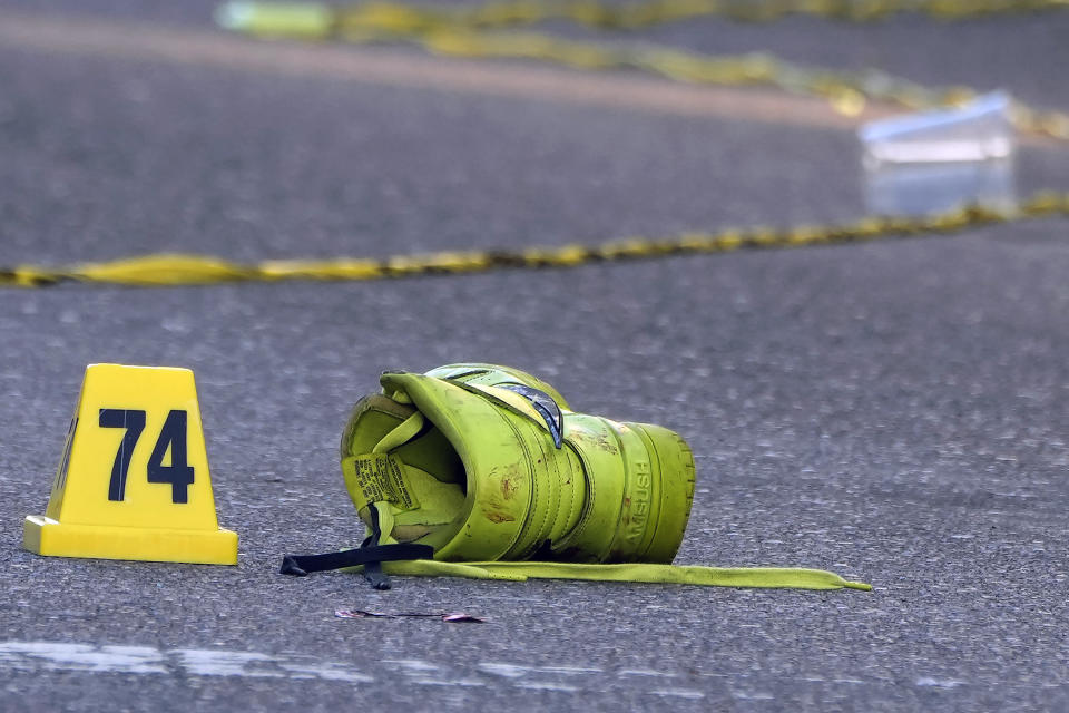 A shoe lays near an evidence marker in the street in the Ybor City section of Tampa, Fla., after a shooting early Sunday, Oct. 29, 2023. A fight between two groups turned deadly in a shooting during Halloween festivities. (AP Photo/Chris O'Meara)