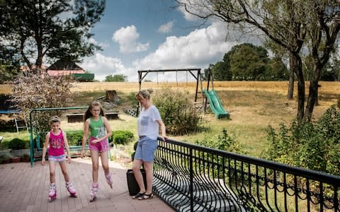 Malwina Kicler, center, and Liliana Kicler, left, of the village of Miejsce Odrzanskie, Poland, - Credit: Kasia Strek/NYTNS / Redux / eyevine&nbsp;