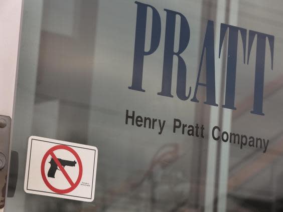 A sign on the front door of the Henry Pratt Company office shows that guns are not allowed in the building (Getty Images)