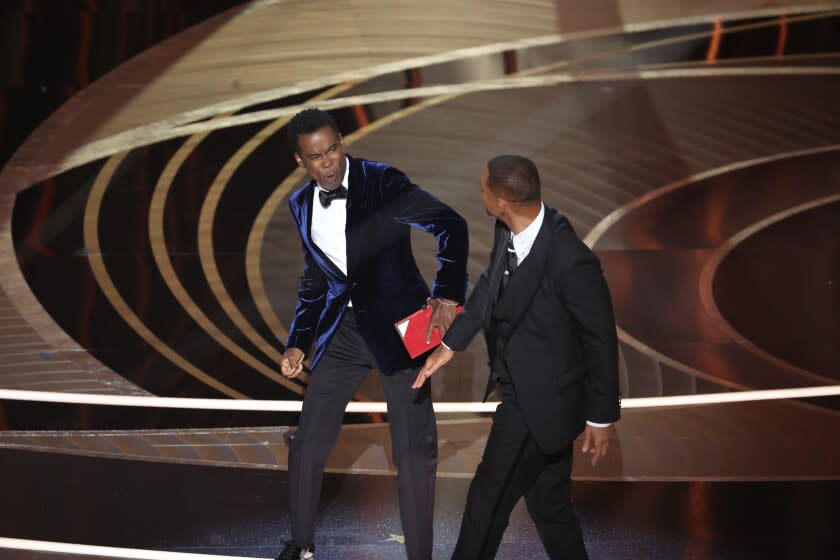 HOLLYWOOD, CA - March 27, 2022. Chris Rock and Will Smith onstage during the show at the 94th Academy Awards at the Dolby Theatre at Ovation Hollywood on Sunday, March 27, 2022. (Myung Chun / Los Angeles Times)