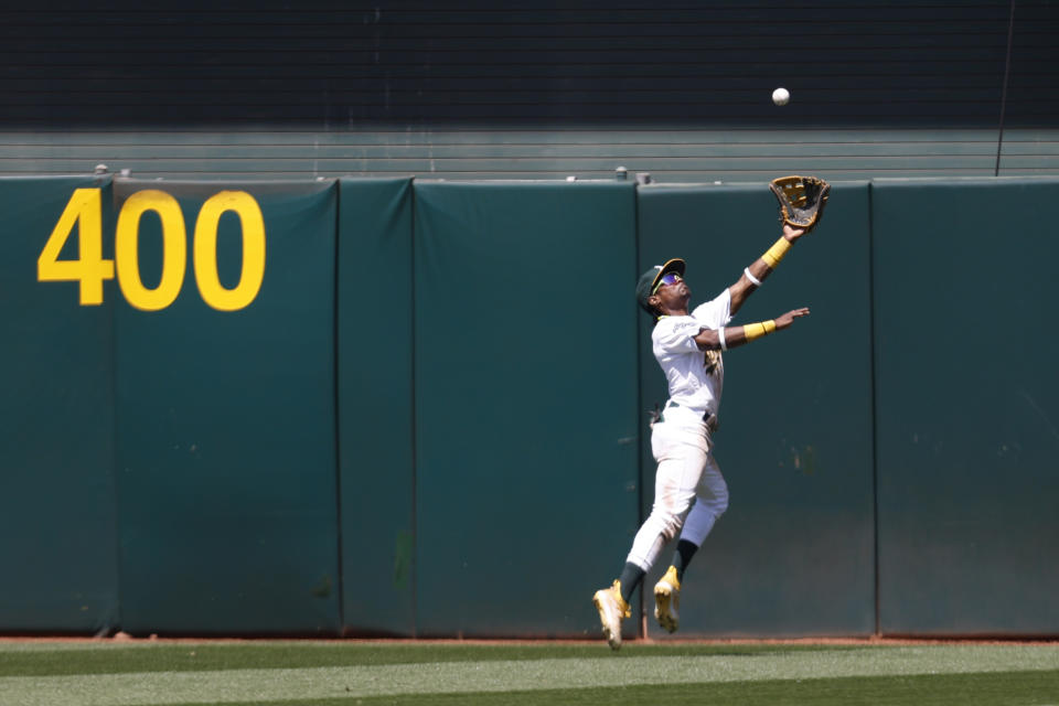 Oakland Athletics center fielder Esteury Ruiz catches a ball hit by Atlanta Braves' Ronald Acuna Jr. during the ninth inning of a baseball game in Oakland, Calif., Thursday, May 31, 2023. (AP Photo/Jed Jacobsohn)