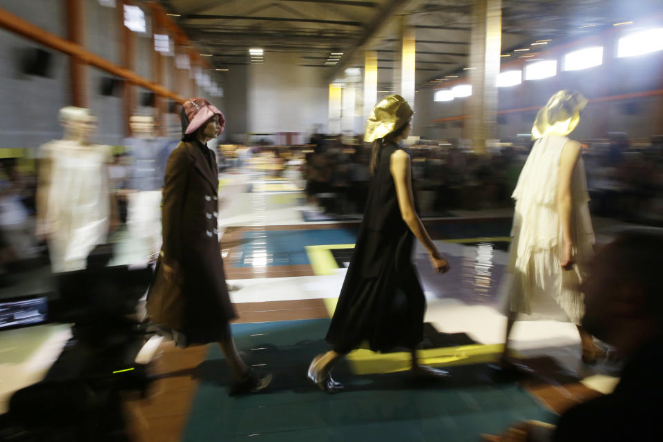 Model Gigi Hadid, left, walks with other models as they wear creations as part of the Prada Spring-Summer 2020 collection, unveiled during the fashion week, in Milan, Italy, Wednesday, Sept. 18, 2019. (AP Photo/Luca Bruno)