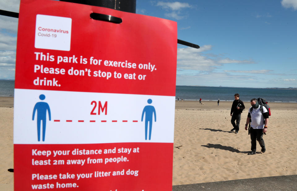 Members of the public walk along the beach front at Portobello as the UK continues in lockdown to help curb the spread of the coronavirus. (Photo by Andrew Milligan/PA Images via Getty Images)