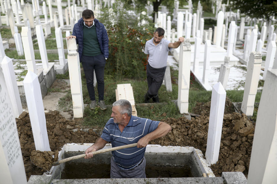 A man digs graves for COVID-19 victims at the Bare cemetery in Sarajevo, Bosnia, Friday, Sept. 24, 2021. Public mistrust of authorities in corruption-plagued Bosnia has created an opening for anti-vaccination movement even though the Balkan nation has the highest rate in Europe of coronavirus deaths and faces a growing number of new infections. So far, despite an abundance of coronavirus vaccines in Bosnia, just under 13 percent of its 3.3 million people had been fully immunized against Covid-19. (AP Photo)