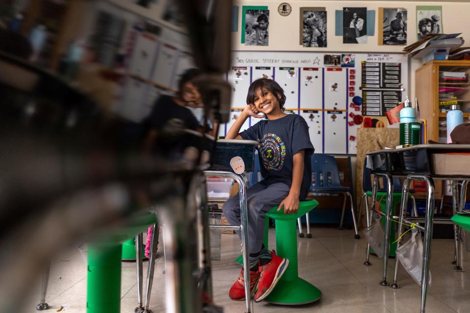 Emerson School third grader Keshav Hebsur, center, 8, sits in his classroom at the school in Ann Arbor on March 2, 2023. Keshav has nearly 1,300 pi digits memorized and won't stop until he reaches 100,000 digits.