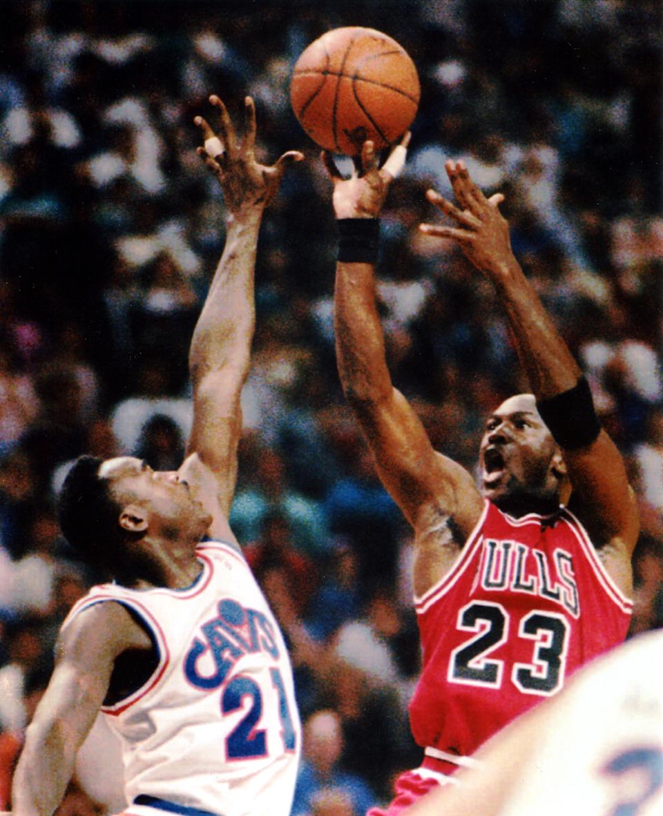 The Chicago Bulls' Michael Jordan makes the game-wining shot over the Cleveland Cavaliers' Gerald Wilkins in Game 4 of the Eastern Conference semifinals, May 17, 1993, in Richfield, Ohio.