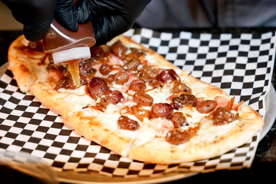 Chaya Pennington displays a pizza on Jan. 31 at the Metro Tech Cafe in Oklahoma City.