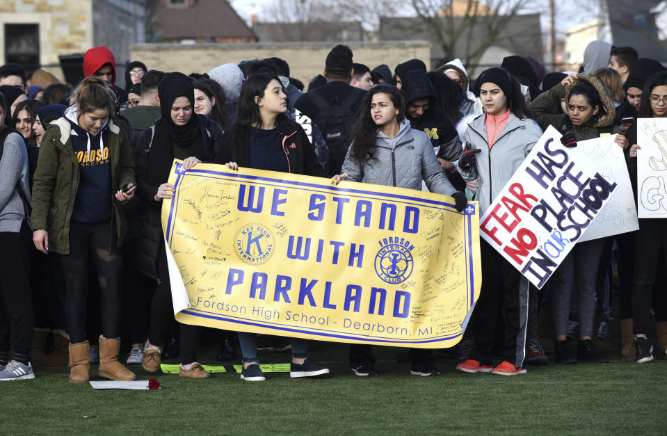 FILE - In this Wednesday, March 14, 2018 file photo, Fordson High School students in Dearborn, Mich., carry signs as they participate in a nationwide walkout to bring attention and to honor to the 17 students killed in a mass shooting at the Marjory Stoneman Douglas High School in Parkland, Fla. (Max Ortiz/Detroit News via AP)