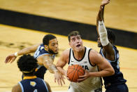 Iowa center Luka Garza, center, drives to the basket between Southern University's Andre Allen, left, and Samkelo Cele, right, during the first half of an NCAA college basketball game, Friday, Nov. 27, 2020, in Iowa City, Iowa. (AP Photo/Charlie Neibergall)