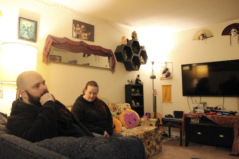 Taylor Wood and her boyfriend, Ryan Bowser, talk about their financial situation inside their Corvallis, Ore., apartment on Dec. 11, 2020. The family is unsure where they will go if an eviction moratorium is not extended and they are kicked out of their home. (AP Photo/Sara Cline)