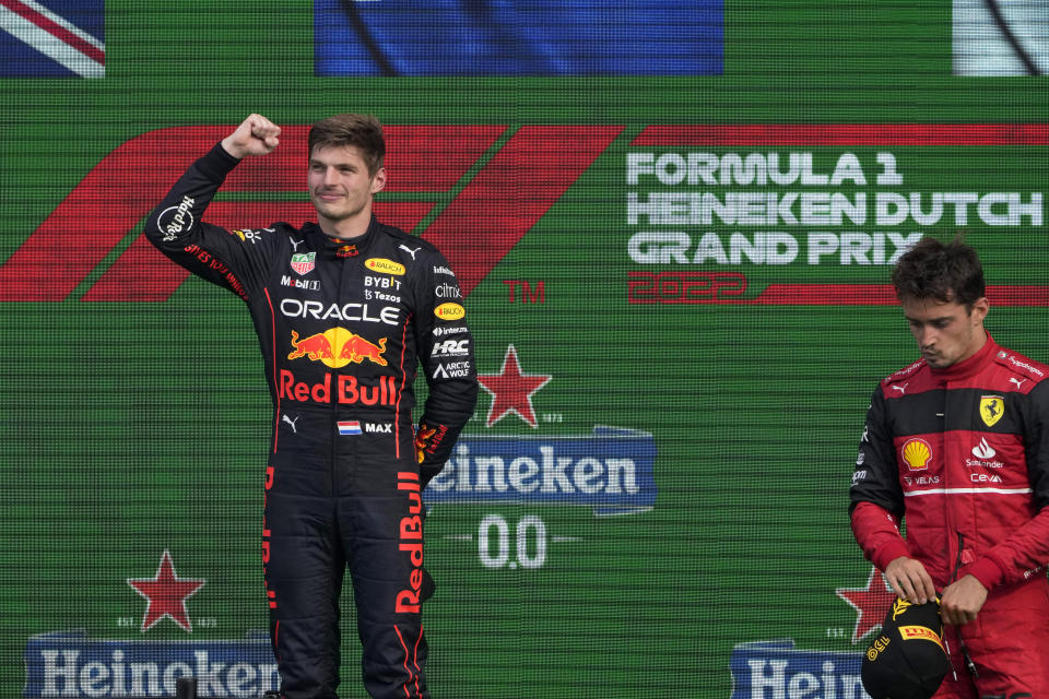 Red Bull driver Max Verstappen of the Netherlands celebrates on the podium after winning the Formula One Dutch Grand Prix auto race, at the Zandvoort racetrack, in Zandvoort, Netherlands, Sunday, Sept. 4, 2022. At right is third placed Ferrari driver Charles Leclerc of Monaco. (AP Photo/Peter Dejong)