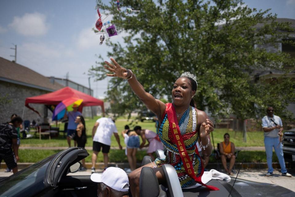 Juneteenth Ambassador Madison Swain tosses candy towards children during the Juneteenth Parade in Galveston, Texas, U.S., June 17, 2023. 