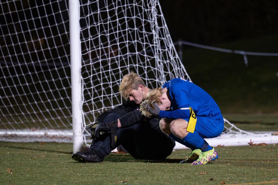 Douglas goalie Gavin Gualtieri, left, and teammate Colin Loehr sit dejected after the Tigers fell in a shootout to Westport in the D5 state boys' soccer final on Saturday at Doyle Field.