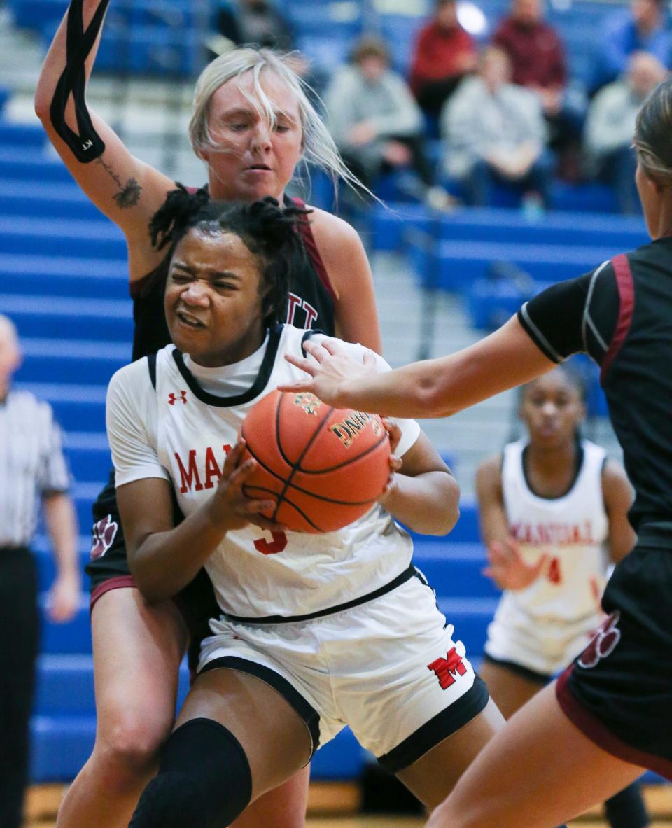 Manual's Jakayla Thompson (3) works under the basket against the Bullitt Central defense during the Girls LIT at the Valley High School gym in Louisville, Ky. on Jan. 25, 2023.