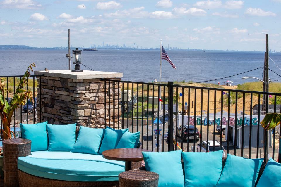 The New York City skyline seen from the rooftop lounge area of The Beach Gallery, a triple decker multi-purpose building with a cafe, brunch dining room, tea room and rooftop bar, in Keansburg.