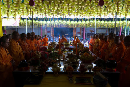 Buddhist monks pray at a temple to mark the eve of the vegetarian festival in Bangkok's Chinatown, Thailand, October 19, 2017. Picture taken October 19, 2017. REUTERS/Athit Perawongmetha