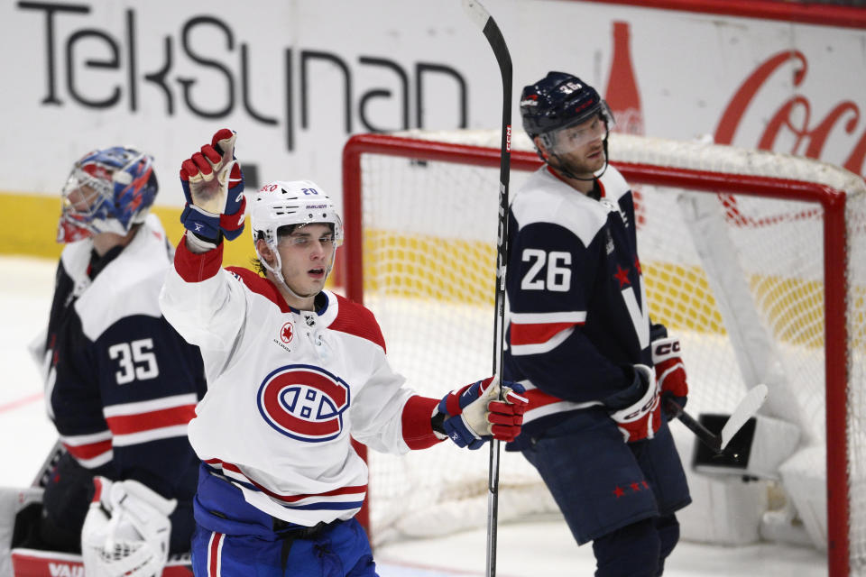 Montreal Canadiens left wing Juraj Slafkovsky (20) celebrates his goal during the third period of an NHL hockey game in front of Washington Capitals goaltender Darcy Kuemper (35) and right wing Nic Dowd (26), Tuesday, Feb. 6, 2024, in Washington. The Canadiens won 5-2. (AP Photo/Nick Wass)
