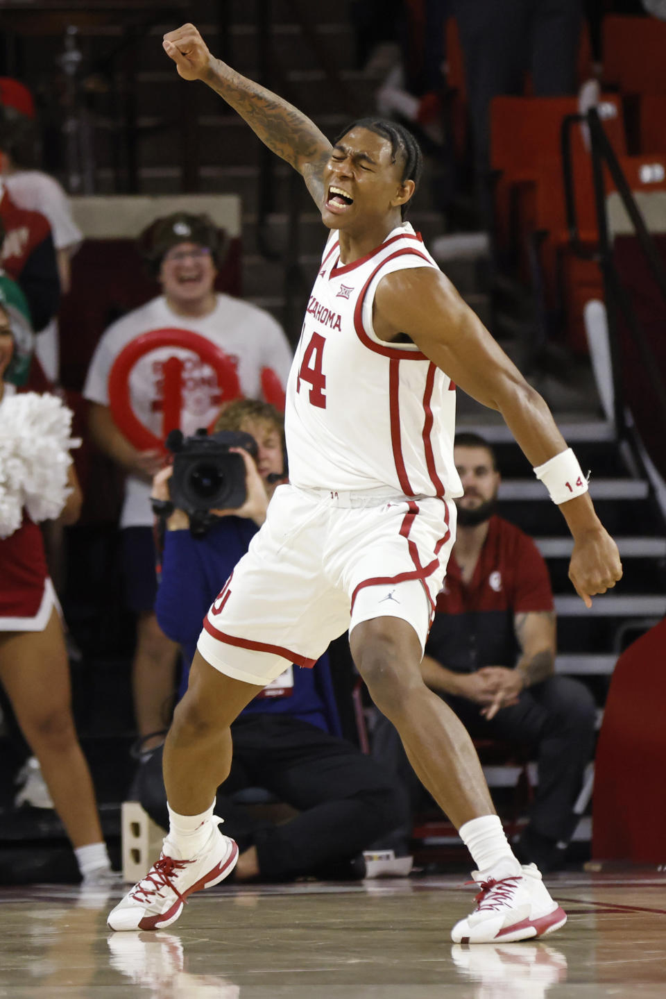 Oklahoma forward Jalon Moore (14) celebrates after dunking the ball against Providence during the first half of an NCAA college basketball game, Tuesday, Dec. 5, 2023, in Norman, Okla. (AP Photo/Nate Billings)