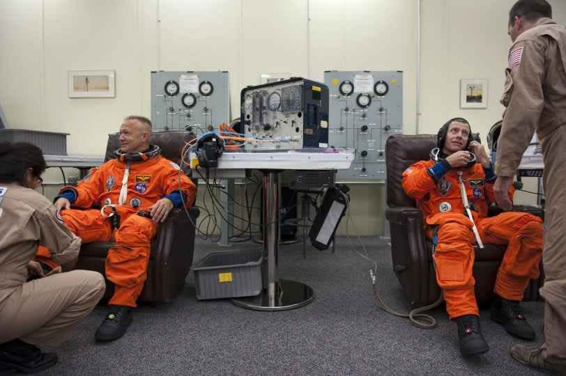 Astronauts Doug Hurley and Chris Ferguson in orange ACES launch-and-entry suits