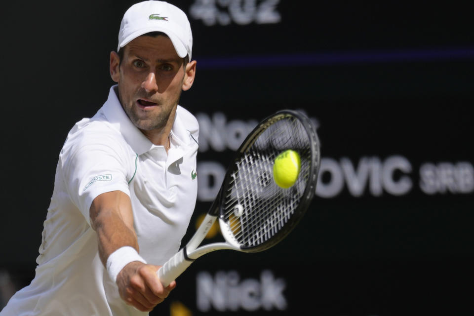 Serbia's Novak Djokovic returns to Australia's Nick Kyrgios during the final of the men's singles on day fourteen of the Wimbledon tennis championships in London, Sunday, July 10, 2022. (AP Photo/Kirsty Wigglesworth)