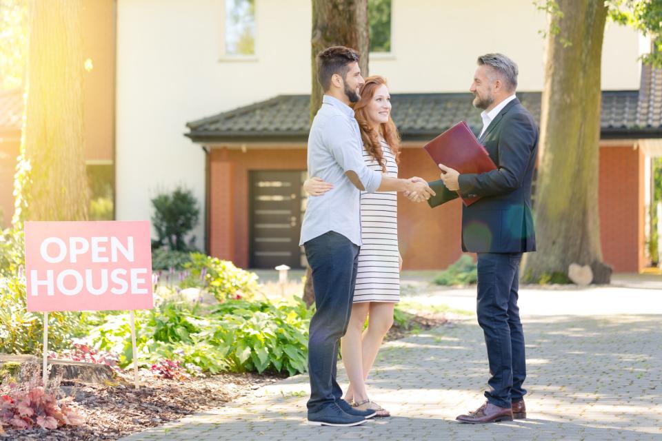 Couple meeting realtor at open house.