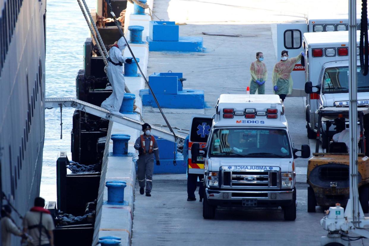 Rescue workers stand by the Zaandam of the Holland America Line cruise ship as the vessel arrives at Port Everglades in Florida: REUTERS