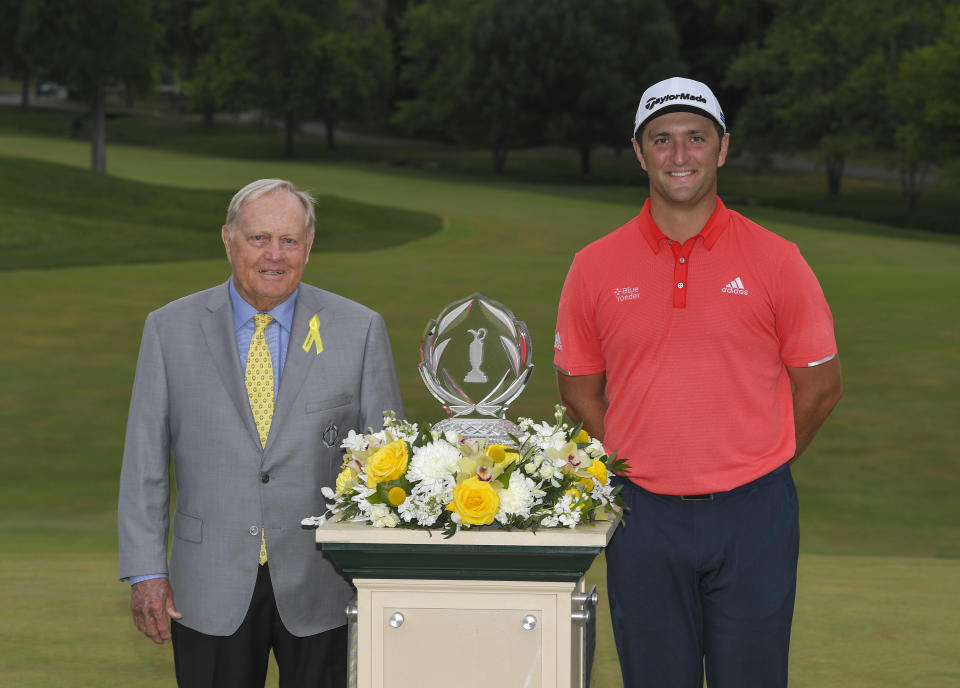 Jon Rahm celebrates with the winner's trophy with Jack Nicklaus.