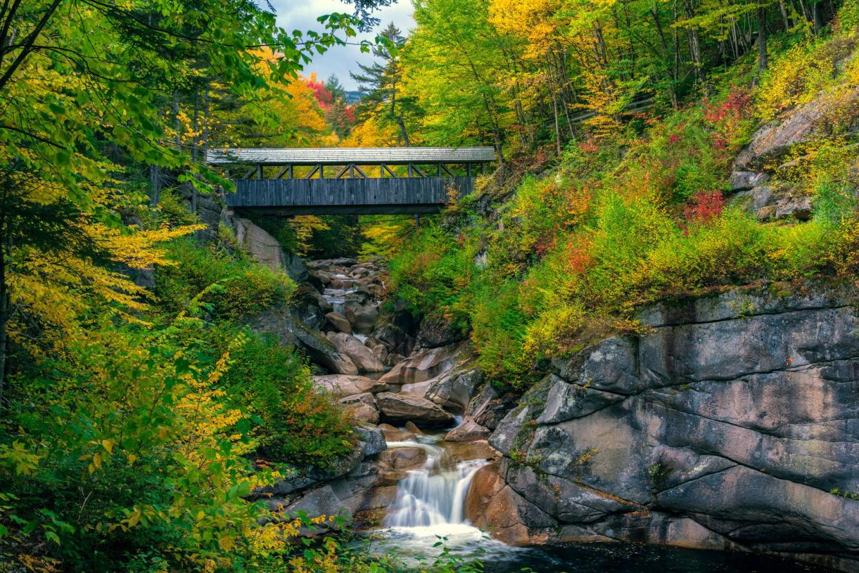 The Sentinel Pine covered bridge spans the Pemigewasset River in the Flume gorge, near Lincoln, NH.