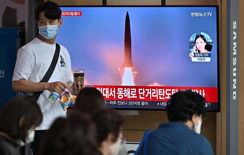 People watch a television screen showing a news broadcast with file footage of a North Korean missile test, at a railway station in Seoul on September 25, 2022. - North Korea fired a ballistic missile on September 25, Seoul's military said, just days after a US aircraft carrier arrived for joint drills with the South in a show of force against Pyongyang. (Photo by Jung Yeon-je / AFP) (Photo by JUNG YEON-JE/AFP via Getty Images)